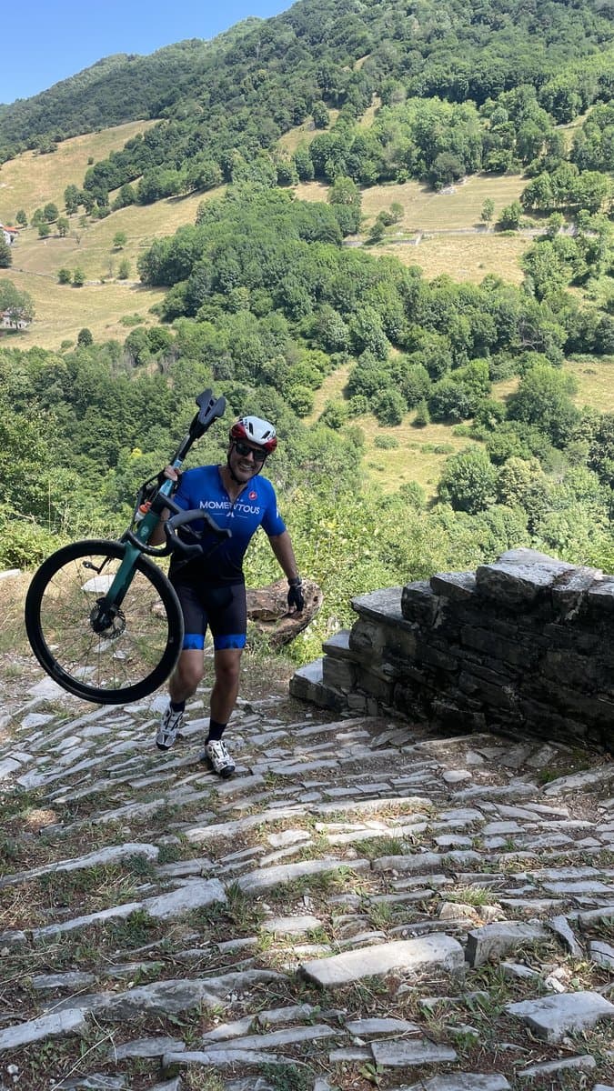 Cyclist Carrying Bike Uphill