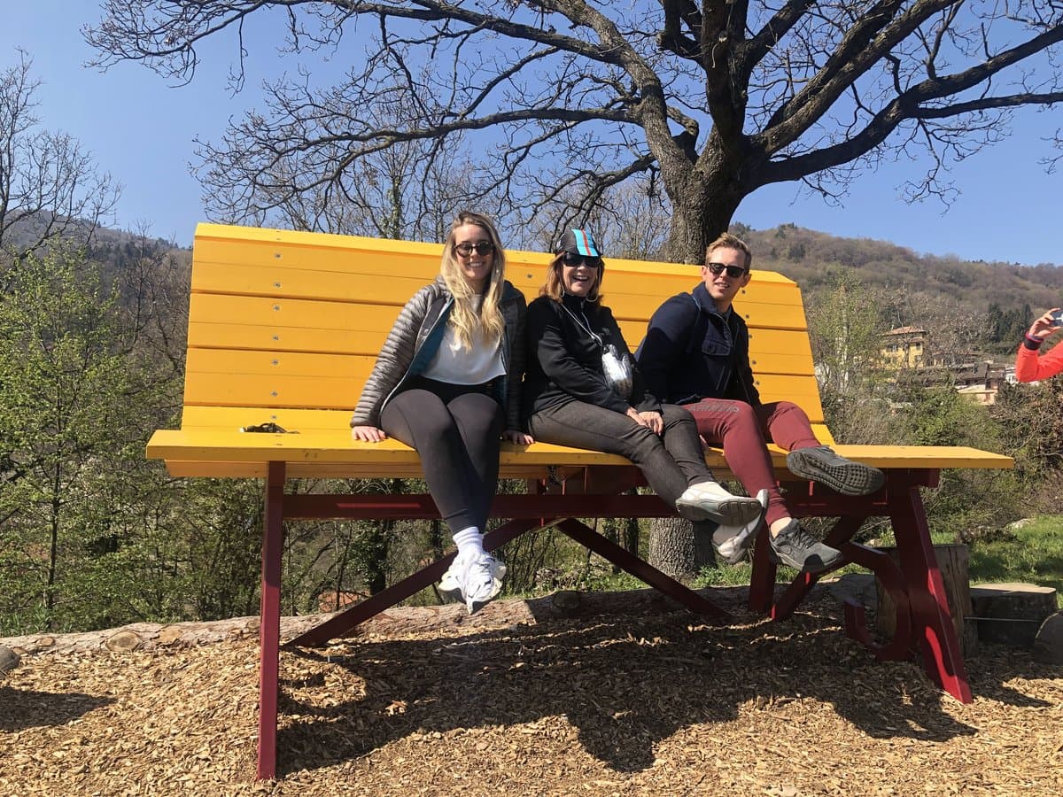 Cyclists on yellow bench in Bellagio