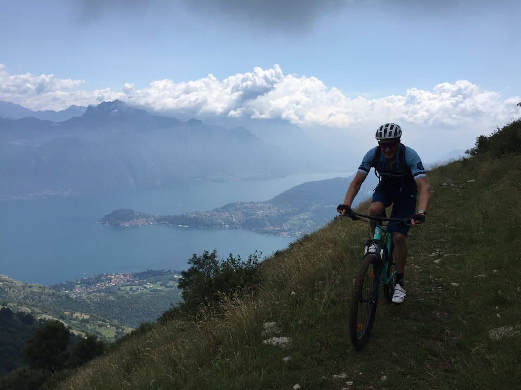 Cyclist on Mountain Trail overlooking Lake Como Cyclist on Mountain Trail overlooking Lake Como