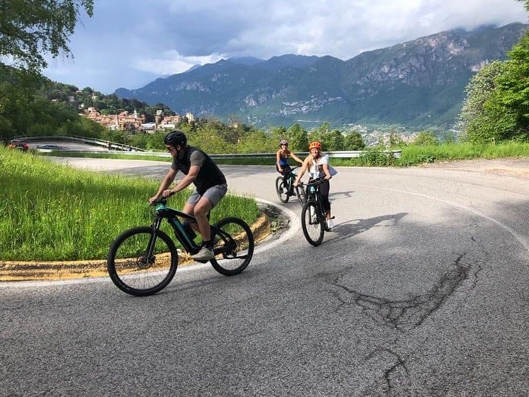 Cyclists on a Curved Road Near Lake Como Cyclists on a Curved Road Near Lake Como