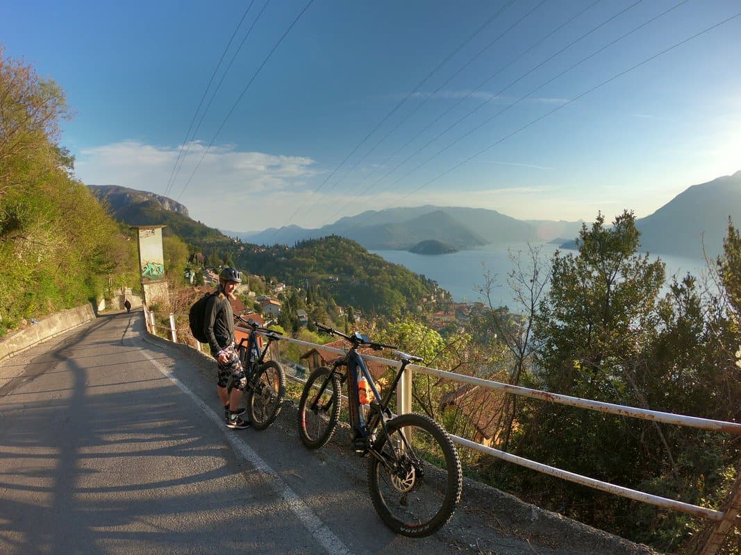 Cyclist with Bikes Overlooking Lake Como Cyclist with Bikes Overlooking Lake Como